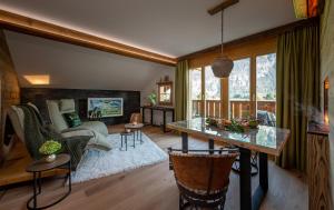 a living room with a table and a couch at SALZANO Apartments in Interlaken