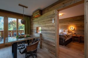 a bedroom with a bed and a wooden wall at SALZANO Apartments in Interlaken +37 photos