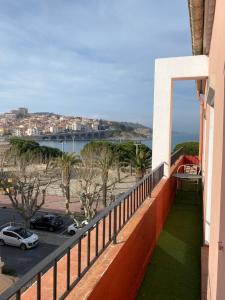 a balcony of a building with a view of the ocean at Hotel Les Pecheurs in Banyuls-sur-Mer