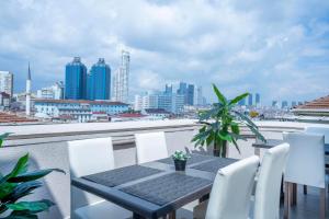 a table and chairs on a balcony with a view of a city at Valide Hotel in Istanbul