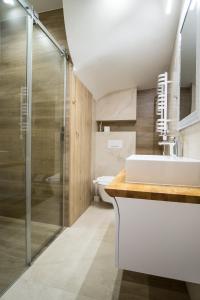 a bathroom with a sink and a shower at Apartament Luna Góralka in Zakopane