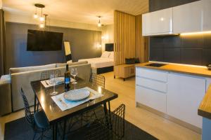 a kitchen and a living room with a table with chairs at marizas luxury suites #2 in Thessaloniki +44 photos