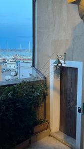 a door to a building with a view of a harbor at La Finestra Sul Porto in Termoli