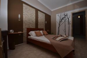 a bedroom with a bed and a brick wall at Karmik Concept Apartments in Afantou