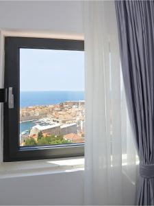 a window with a view of the ocean at Luxury Amarin Apartment in Dubrovnik
