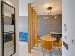 jadalnia i kuchnia ze stołem i żółtymi krzesłami w obiekcie Luxury Amarin Apartment w Dubrowniku