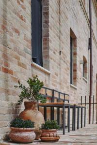 a couple of large vases sitting next to a building at Monna Terra B&B in Fermo