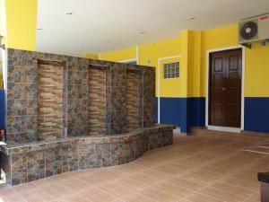 a lobby with yellow and blue walls and a door at Sun Inns Rest House Kuantan in Kuantan