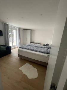 a bedroom with a bed and a large window at Moderne Ferienwohnung an der Lichtentaler Allee in Baden-Baden