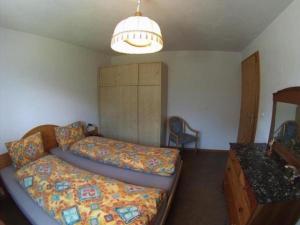 een slaapkamer met een bed en een dressoir bij Alvetern Tschuetta in Scuol