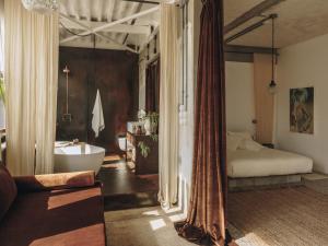 a bedroom with a bed and a bath tub and a tub at Mona Athens in Athens
