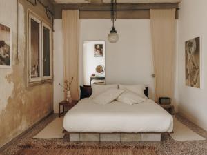 a bedroom with a white bed in a room at Mona Athens in Athens