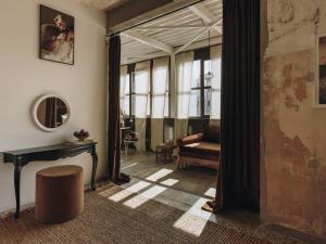 a living room with a table and a couch at Mona Athens in Athens