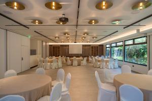 a conference room with white tables and white chairs at Emmantina Hotel in Athens
