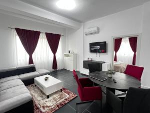 a living room with a couch and a table at Cozy Aparthotel - Central City Suceava in Suceava