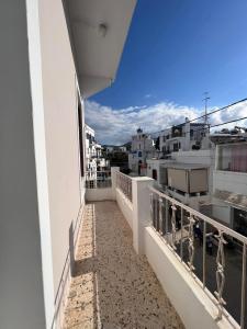a balcony with a view of a city at Tinos Central Perfection in Tinos