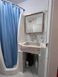 a bathroom with a sink and a mirror at Tinos Central Perfection in Tinos +16 photos