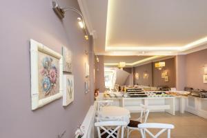 a salon with white chairs and a table in a room at Mr. Bird Hotel in Istanbul