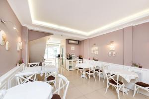 a dining room with white tables and chairs at Mr. Bird Hotel in Istanbul