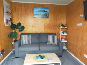 a living room with a couch and a coffee table at The Old Sunday School in Dunedin