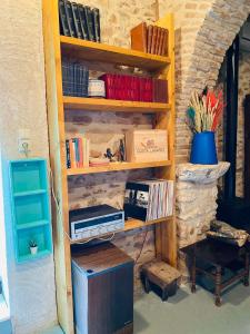 a book shelf with books and other items on it at Old winery in Spata