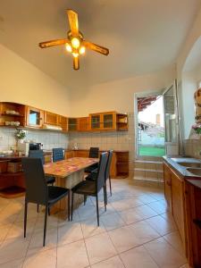 a kitchen with a table and chairs and a ceiling fan at Centrum Hostel in Pécs