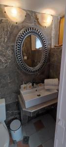 a bathroom with a sink and a mirror at Dream Catcher Studio in Skopelos Town