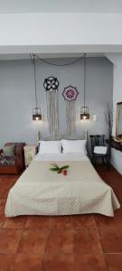 a bedroom with a large white bed with flowers on it at Dream Catcher Studio in Skopelos Town