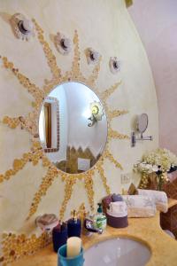 a bathroom with a sink and a mirror at Case Vacanze La Conia in Cannigione