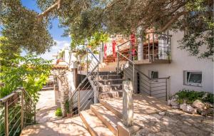 a set of stairs leading up to a building at Nice Apartment In Stara Baska 1 in Stara Baška