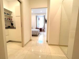 a hallway with a mirror and a bedroom at SOLEIL LUXURY APARTMENT in Maiori +4 photos