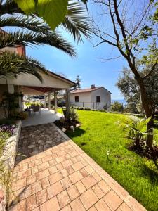 a brick walkway leading to a house at Pet friendly Apartments Licul in Rabac