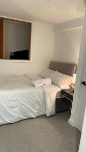a bedroom with a bed and a desk with a mirror at 2 Bedroom Maisonette in Salford in Manchester
