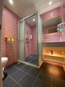 a pink bathroom with a shower and a toilet at 191 Hotel in Taoyuan