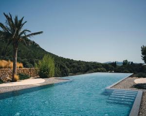 a swimming pool with a mountain in the background at Es Racó d´Artà in Artá