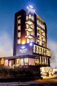 a building with a sign that reads dress hotel at Blisss Hotel, Kolhapur in Kolhapur