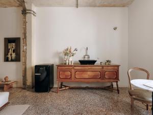 a room with a dresser and a black refrigerator at Mona Athens in Athens