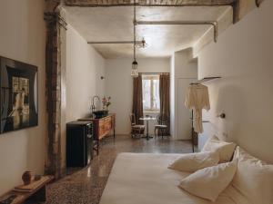 a bedroom with a bed and a table in a room at Mona Athens in Athens