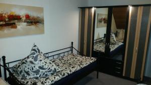 a bedroom with a bed and a mirror at Unterkunft A.Lambrecht in Oberhausen