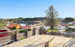 a wooden deck with a view of a city at Stunning Home In Hvik With Wifi 