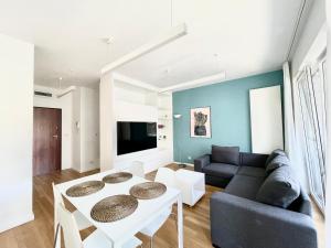a living room with a couch and a table at Elegant Apart-800m Main Square-Parking and lift in Wrocław