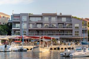 um edifício com barcos ancorados em frente a uma marina em Le Golfe em Porto Pollo