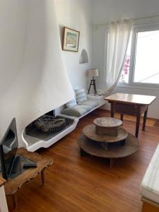 a living room with a couch and a fireplace at The Captain's House in Skiathos