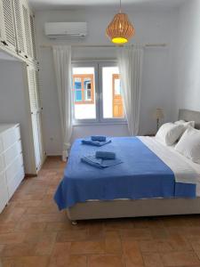 a bedroom with a large bed with blue towels on it at The Captain's House in Skiathos Town