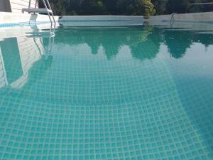 a swimming pool with a clear blue water at Przestronne domki Sztutowo in Sztutowo