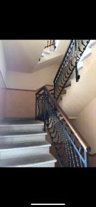 a staircase with metal railings in a building at Zippity Doo Dah - Menaggio Home - Como Lake in Menaggio