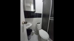 a bathroom with a toilet and a sink at Bm-3 room near the sea with air conditioning and WIFI in Cartagena de Indias +3 photos
