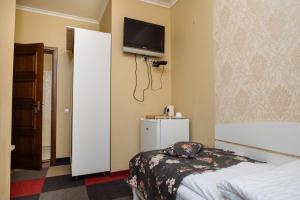 a hotel room with a bed and a tv on the wall at Na Horyzonti in Truskavets