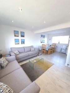 a living room with a couch and a table at Amazing Beach House, Sleeps 8, Pet Friendly in Trearddur