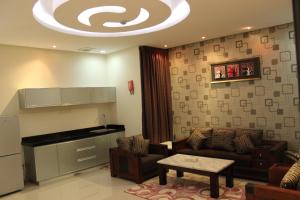 a living room with a couch and a piano at Nadreen Furnished Units in Riyadh